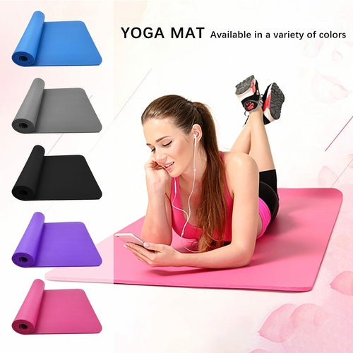 Woman using a smartphone on a pink yoga mat with yoga mats in various colors displayed.