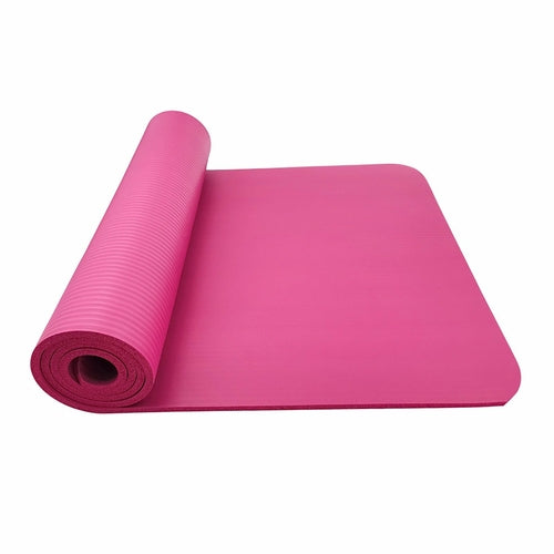 Pink yoga mat rolled up on a white background