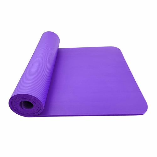 Purple yoga mat rolled out on a white background